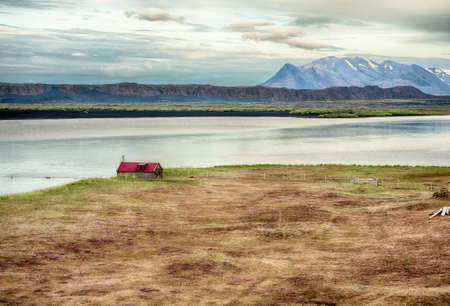 Old abandoned barn. Located in a wild Icelandic landscape in the valley under the mountains in the fjordの写真素材