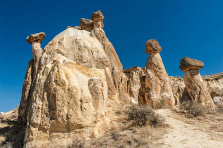 Rocks looking like mushrooms  lit by a setting sun in Cappadocia, Turkeyの写真素材