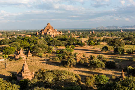 Late afternoon sun shines on Dhammayangyi Pahto Temple and many other pagodas in the ancient city of Bagan, Myanmar.の写真素材