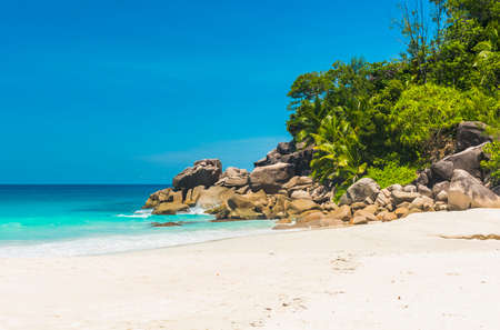 Beautifully shaped granite boulders and a perfect white sand at the famous Anse Georgette, Praslin island, Seychellesの写真素材