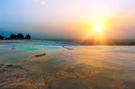 Beautiful vivid sunset over the travertine terraces and pools at Pamukkale, Turkeyの写真素材