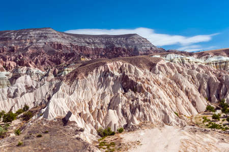 Detailed photo of vivid pink rock formations with caves from above in Cappadocia, Turkeyの写真素材