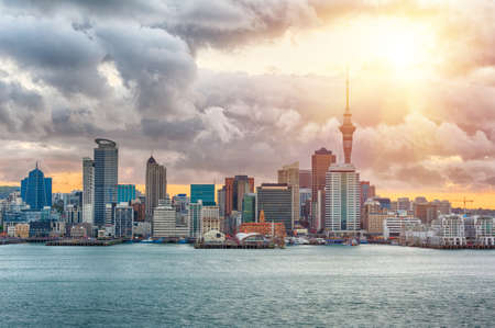 Skyline photo of the biggest city in the New Zealand, Auckland. The photo was taken during the golden sunset across the bayの写真素材