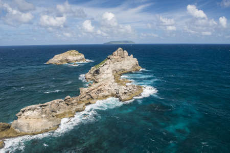 Rocks in the sea seen from the Pointe des Chateaux, the most Eastern point of French island  of Guadeloupein the Caribbeanの写真素材