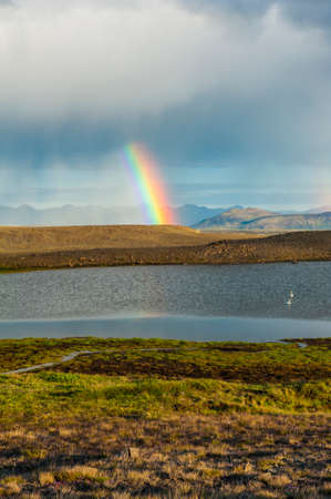 Glacial lake on Iceland and rainy clouds with rainbowの写真素材