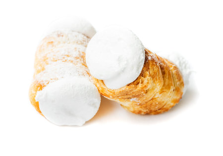 Two small delicious cream rolls on a white background