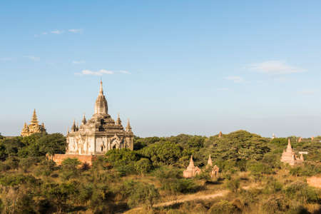 Late afternoon sun shines on old pagodas of an ancient city of Bagan, Myanmar