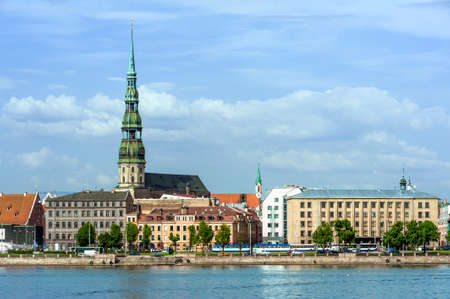 Skyline of Riga seen across the river Daugava. The tallest building on the picture is the St. Peter's Churchの写真素材