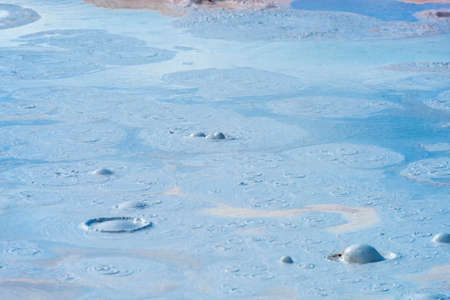 Hot boiling mud at fumarole is bubbling and exploding at mudpots in Yellowstone national park.Wyoming, USAの写真素材