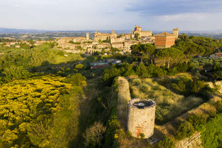 Evening photo of small historic town Lucignano in Tuscany from above along with old Medici fort tower, Italyの写真素材
