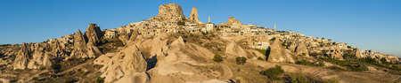 Ancient town and a castle of Uchisar dug from a mountains after sunrise, Cappadocia, Turkey.Panoramaのeditorial素材