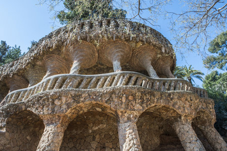 BARCELONA, SPAIN - MARCH 22, 2019: Park Guell by Antonio Gaudi. Stone colonnade resembling tree trunks by Antonio Gaudi in Park Guell, Barcelona. Spainのeditorial素材