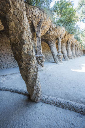 BARCELONA, SPAIN - MARCH 22, 2019: Park Guell by Antonio Gaudi. Stone colonnade resembling tree trunks by Antonio Gaudi in Park Guell, Barcelona. Spainのeditorial素材