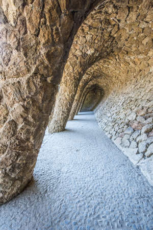 BARCELONA, SPAIN - MARCH 22, 2019: Park Guell by Antonio Gaudi. Stone colonnade resembling tree trunks by Antonio Gaudi in Park Guell, Barcelona. Spainのeditorial素材