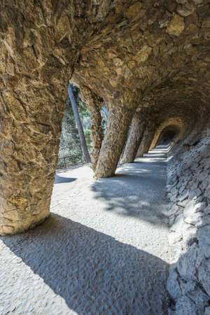 BARCELONA, SPAIN - MARCH 22, 2019: Park Guell by Antonio Gaudi. Stone colonnade resembling tree trunks by Antonio Gaudi in Park Guell, Barcelona. Spainのeditorial素材