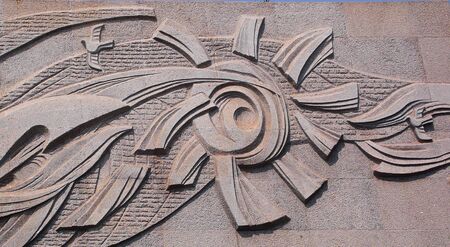 Stone reliefs - the sun and birds; abstract design; in China Rizhao の写真素材
