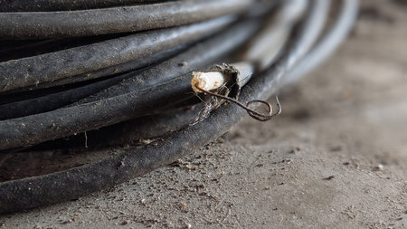 Close-up of electrical wire on the ground. Selective focus.