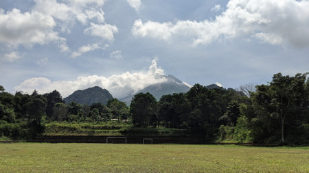 landscape of green field with mountain in the background under blue sky