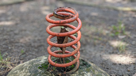 A closeup shot of an old rusty metal spring in the forestの写真素材