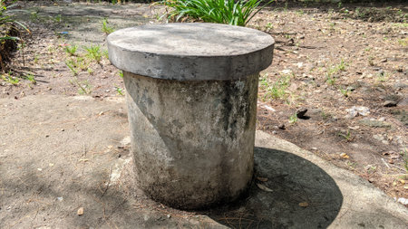 Round concrete bollard on the ground in the garden, stock photoの写真素材