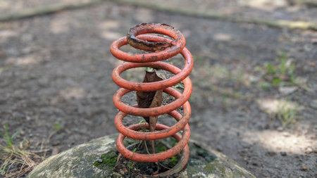 Abandoned rusty spring in the park. Selective focus.の写真素材