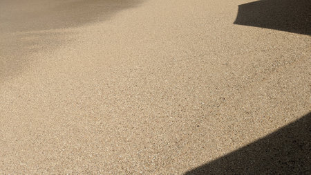 Sand texture and shadow on the ground, closeup of sand backgroundの写真素材