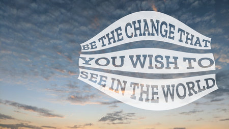A famous quote, Be the change that you wish to see in the world, displayed against a serene sky at dusk or dawn, encouraging personal action for global impact.の写真素材