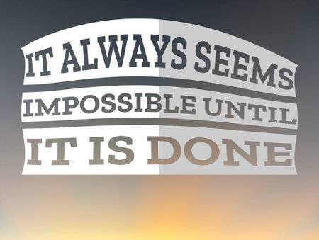 A motivational image with the quote IT ALWAYS SEEMS IMPOSSIBLE UNTIL IT IS DONE in bold, dark gray letters on a white, curved banner against a blurred background of sky and light.の写真素材
