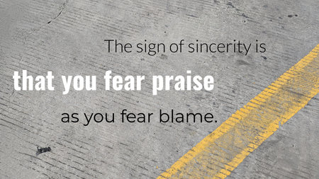 A gray, asphalt surface with a diagonal yellow line and a subtle white text quote. The words that...