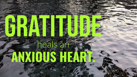 The image shows a quote about gratitude against a rippling water surface with a dark, textured...