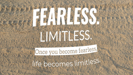 A powerful motivational quote "FEARLESS. LIMITLESS." is displayed on a textured, sandy ground. The quote is accompanied by the phrase "Once you become fearless, life becomes limitless."の写真素材