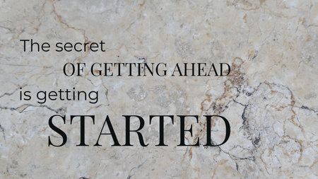 A motivational quote is presented on a marble background. The text reads &quot;The secret OF GETTING AHEAD is getting STARTED,&quot; emphasizing the importance of taking action to achieve your goals.の写真素材