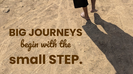 A pair of feet cast a long shadow while walking on a dirt path. The motivational phrase &quot;BIG JOURNEYS begin with the small STEP&quot; is written over the image. It&#39;s a contemplative scene.の写真素材