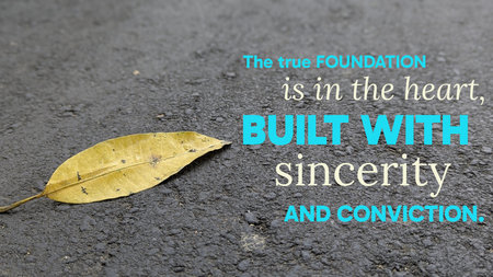 An Islamic quote asserts that the true foundation rests in the heart, built with sincerity, conviction. Bold text is set against dark asphalt, featuring a single prominent yellow leaf.の写真素材