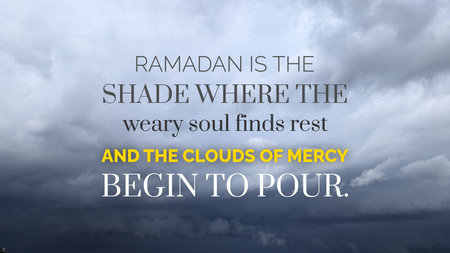 A wide shot captures a moody sky filled with heavy grey clouds. This atmospheric background features shifting layers of overcast mist, creating a sense of impending rain. Bold white, yellow typography overlays the view with a spiritual quote about Ramadan being a shade where the weary soul finds rest.の写真素材