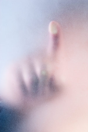 finger on blue glass の写真素材