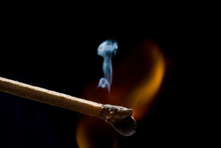 Burning match on black backgroundの写真素材