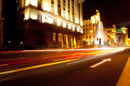 moving car with blur light through city at night