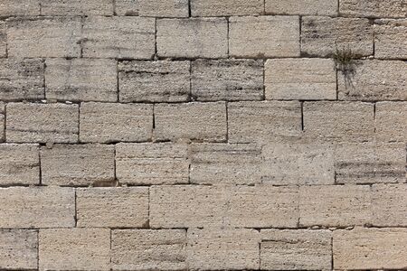 Front view of an old stone brick wallの写真素材