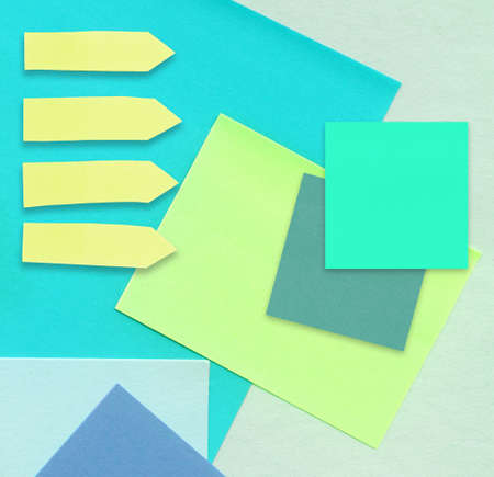 Set of different shape and color reminder notes on bright pastel paper background.の写真素材