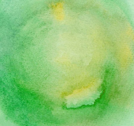 Abstract hand drawn watercolor background on textured paper in green shadesの写真素材
