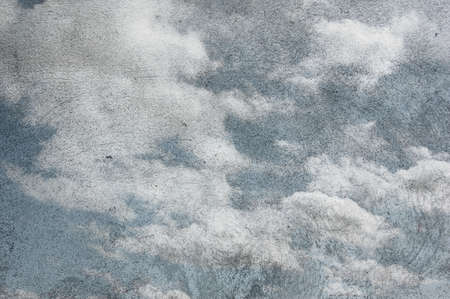 Clouds in the sky on rough grunge paper texture background.の写真素材