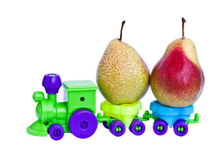A toy train takes ripe pears.の写真素材