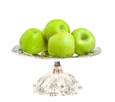 Green apples on a silver platter.の写真素材