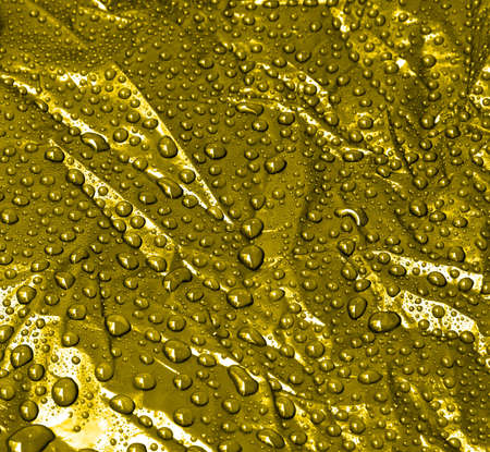 Water droplets on a gold backgroundの写真素材