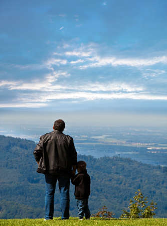 Father and son watching the sunset.の写真素材