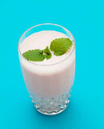 Strawberry milkshake on a blue backgroundの写真素材