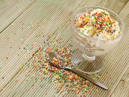 ice cream with the sugar chips on a wooden tableの写真素材