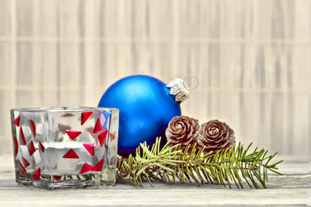 Pine branch with pine cones and Christmas decorations on a board background.の写真素材