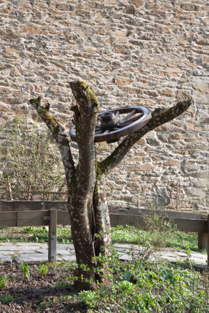 Wagon wheel against a brick wall